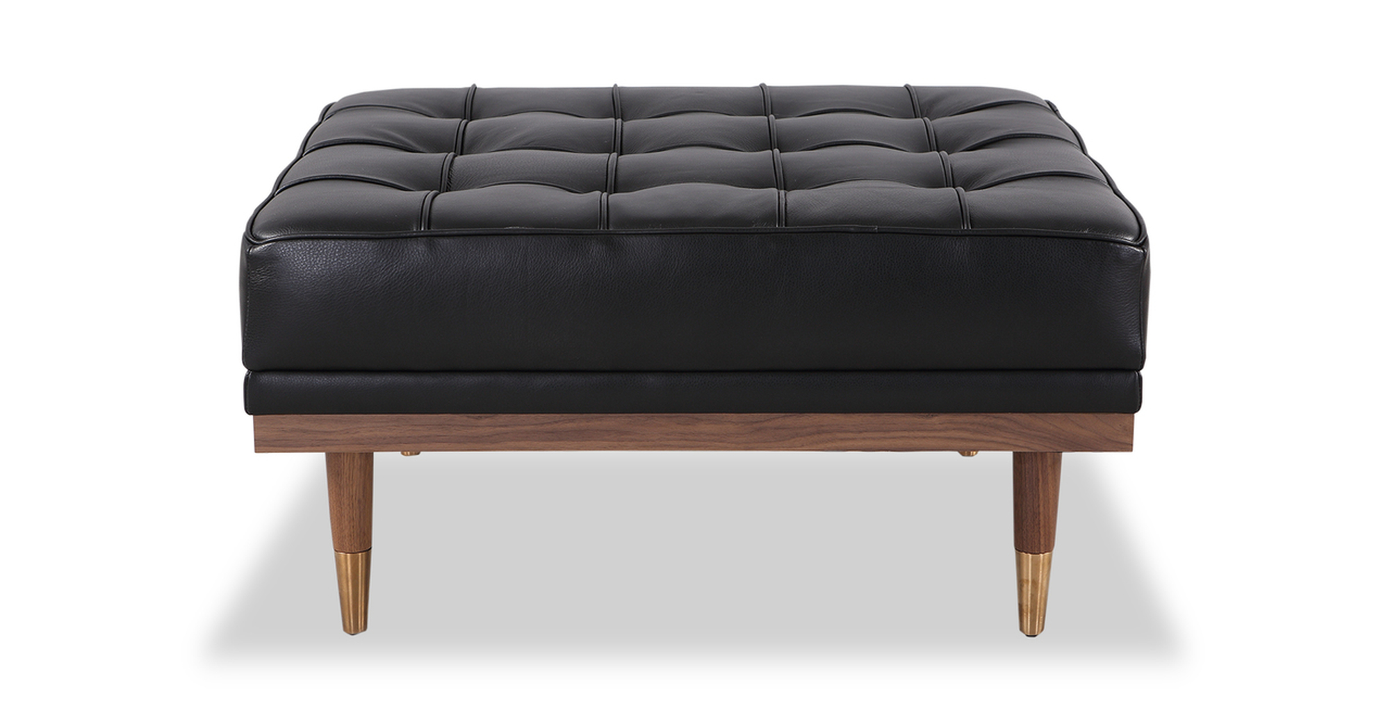 Woodrow ottoman in Black leather. There is button tufting on the ottoman cushions. The frame and legs are walnut wood toned. The legs have brass colored ferrules on the ends. The leather color is black.