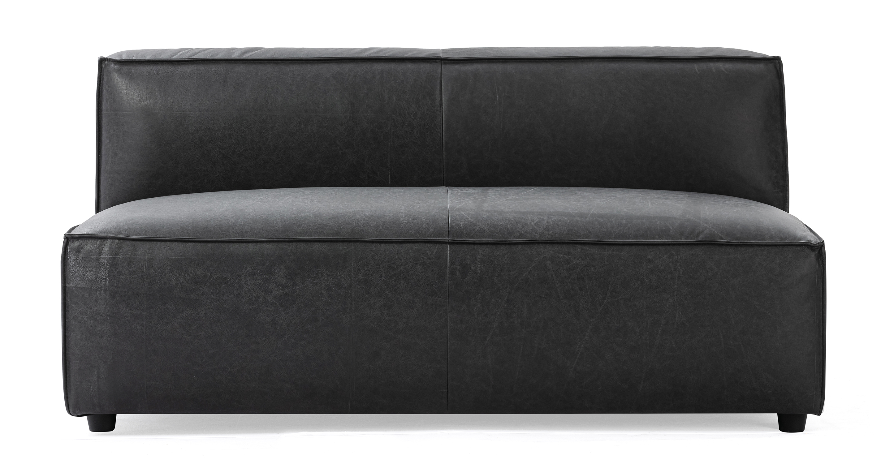 Soho Ebony armless love seat is a low profile love seat mounted to short black legs. The base of the love seat is a large once piece cushion. Mounted to the back of the love seat is a rectangle one piece back. The cushions having piping along the edge and a center stitching seam. This item is part of a modular series were more pieces can be added.