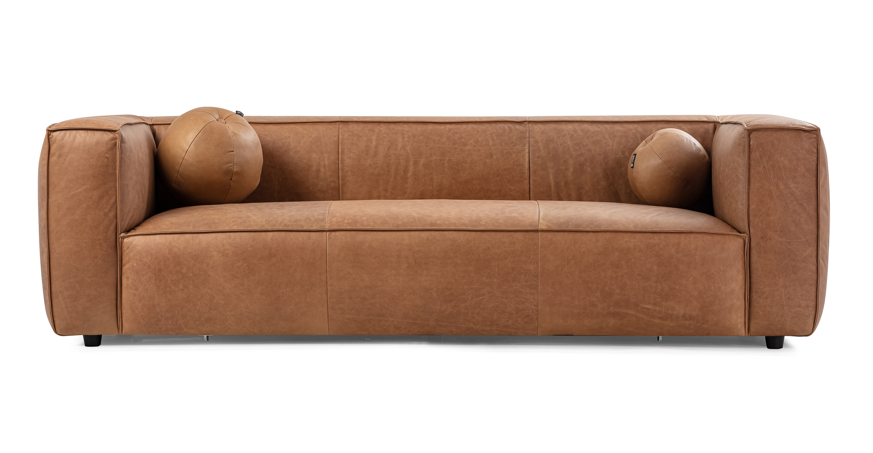 Soho Chestnut 3.5 sofa has a modern and sleek low profile. The sofa is supported by small black legs that allow the sofa to be close to the floor without touching. The sofa seat cushion is one thick solid piece, the arms and back are rectangle in shape. All the cushion edges are finished in piping and have interest seams to visually divide up the one seat cushion. Two matching round orb pillows are included.