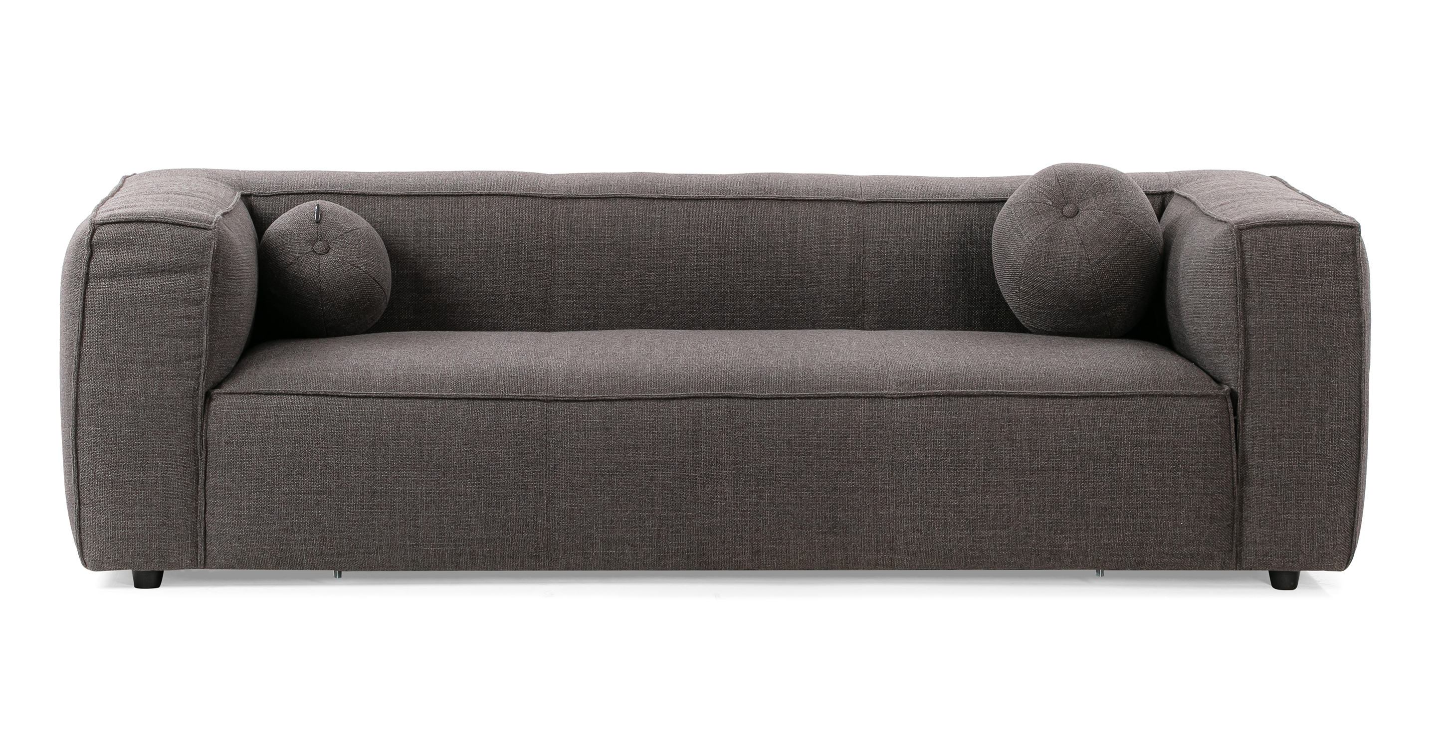 Soho Dior 3.5 sofa has a modern and sleek low profile. The sofa is supported by small black legs that allow the sofa to be close to the floor without touching. The sofa seat cushion is one thick solid piece, the arms and back are rectangle in shape. All the cushion edges are finished in piping and have interest seams to visually divide up the one seat cushion. Two matching round orb pillows are included.