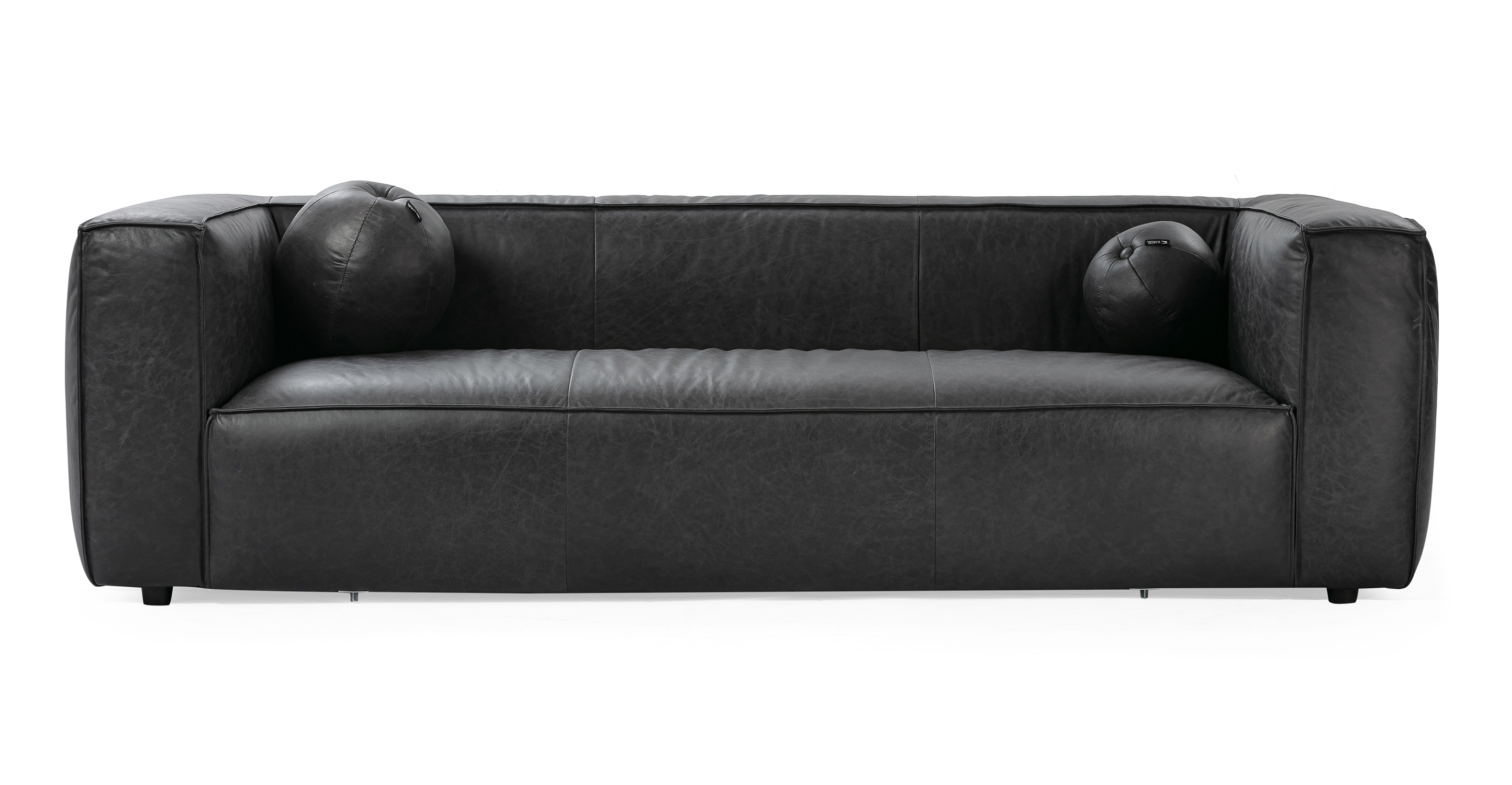 Soho Ebony 3.5 sofa has a modern and sleek low profile. The sofa is supported by small black legs that allow the sofa to be close to the floor without touching. The sofa seat cushion is one thick solid piece, the arms and back are rectangle in shape. All the cushion edges are finished in piping and have interest seams to visually divide up the one seat cushion. Two matching round orb pillows are included.