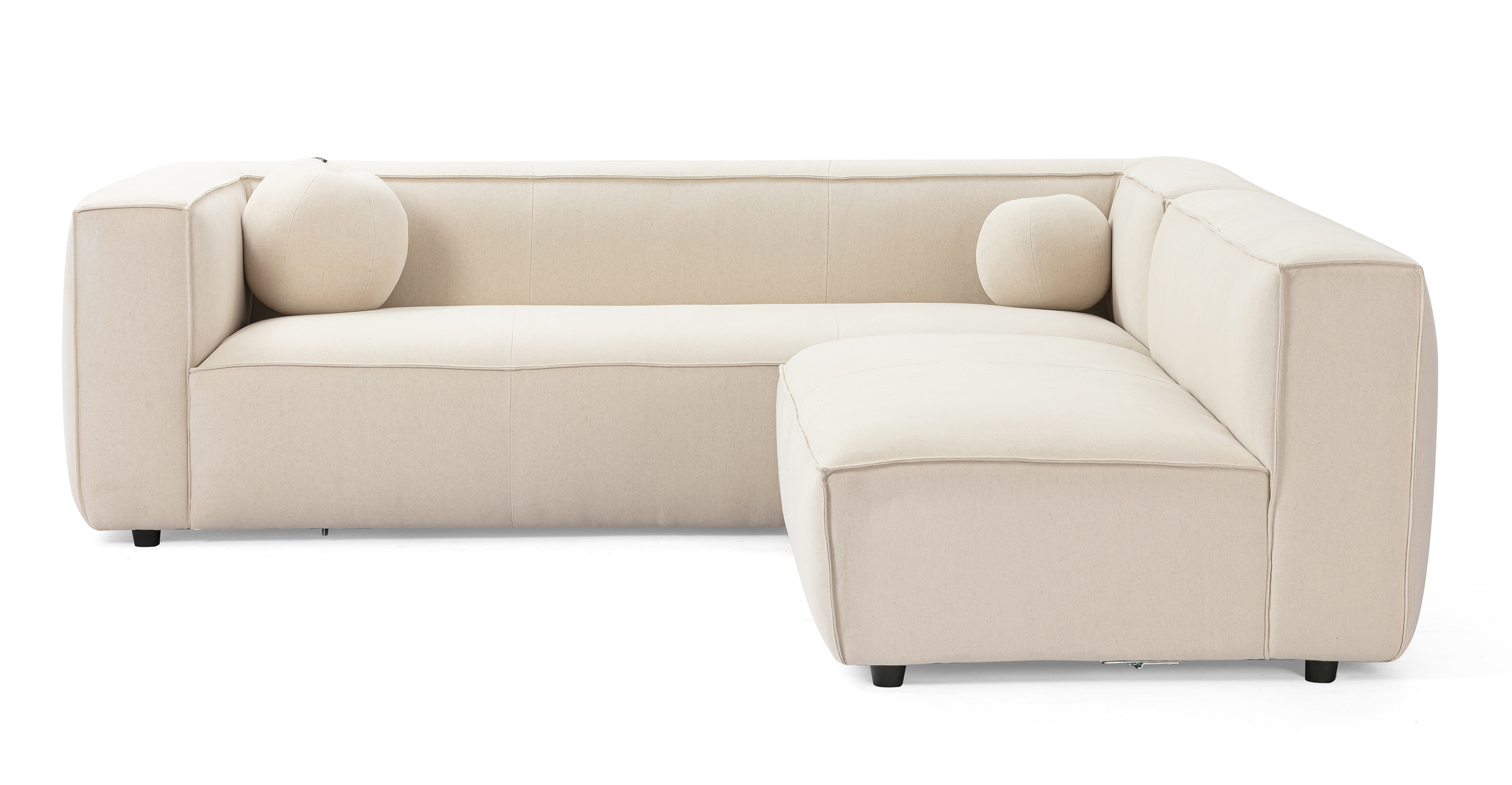 Soho Canvas 96 reversible sofa has a modern and sleek low profile. The modular set connects a 3.5 sofa with arms, to an armless sofa, creating a unique L shape. This series is supported by small black legs that allow the sofa to be close to the floor without touching. The sofa seat cushion is one thick solid piece, the arms and back are rectangle in shape. All the cushion edges are finished in piping and have interest seams to visually divide up the one seat cushion. Two matching round orb cushions are included.